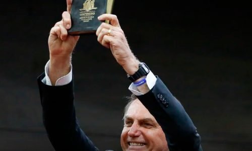 Bolsonaro segurando a Biblia e feliz